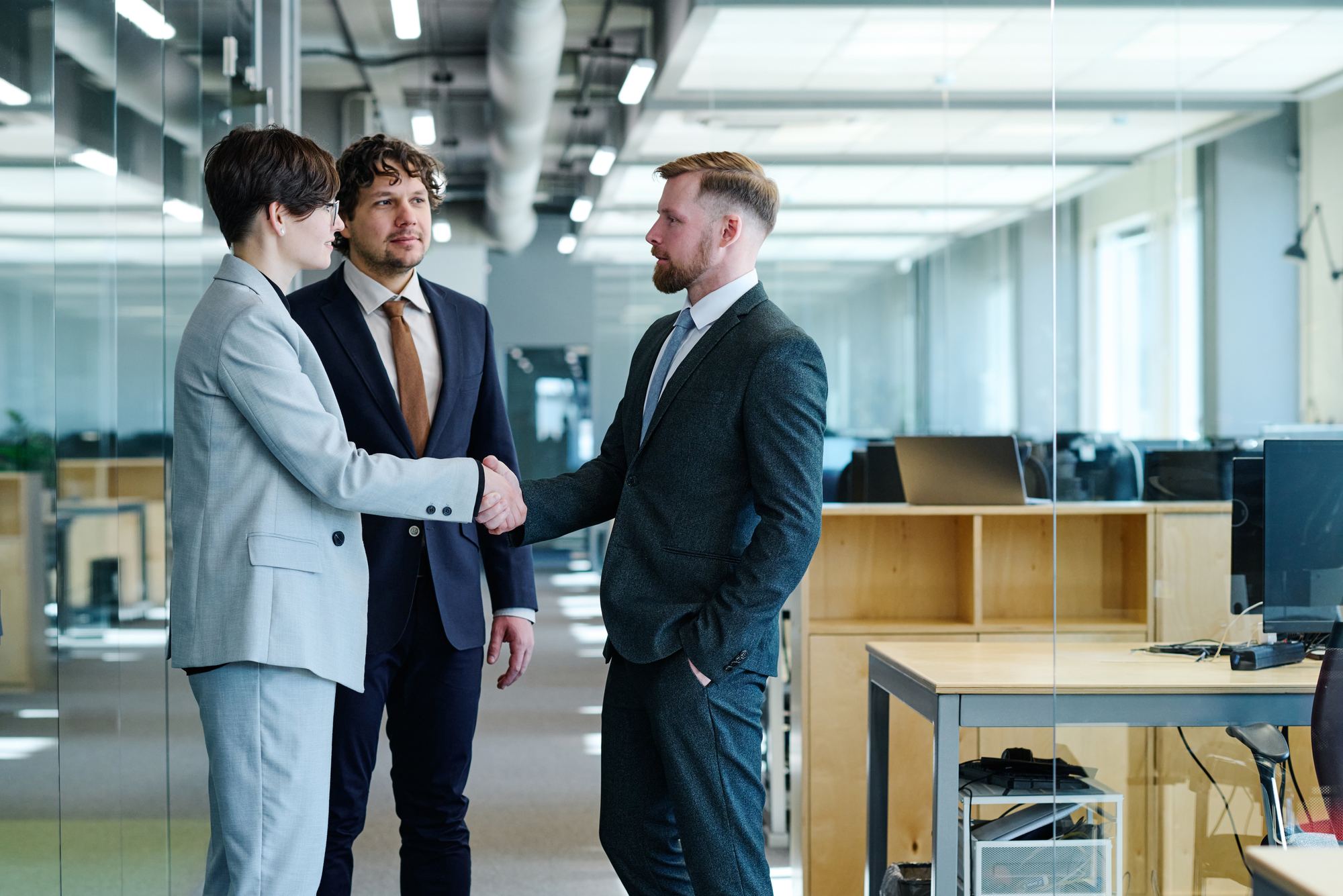 Colleagues shaking hands in a modern office